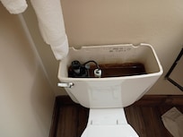 No cover on back of toilet.