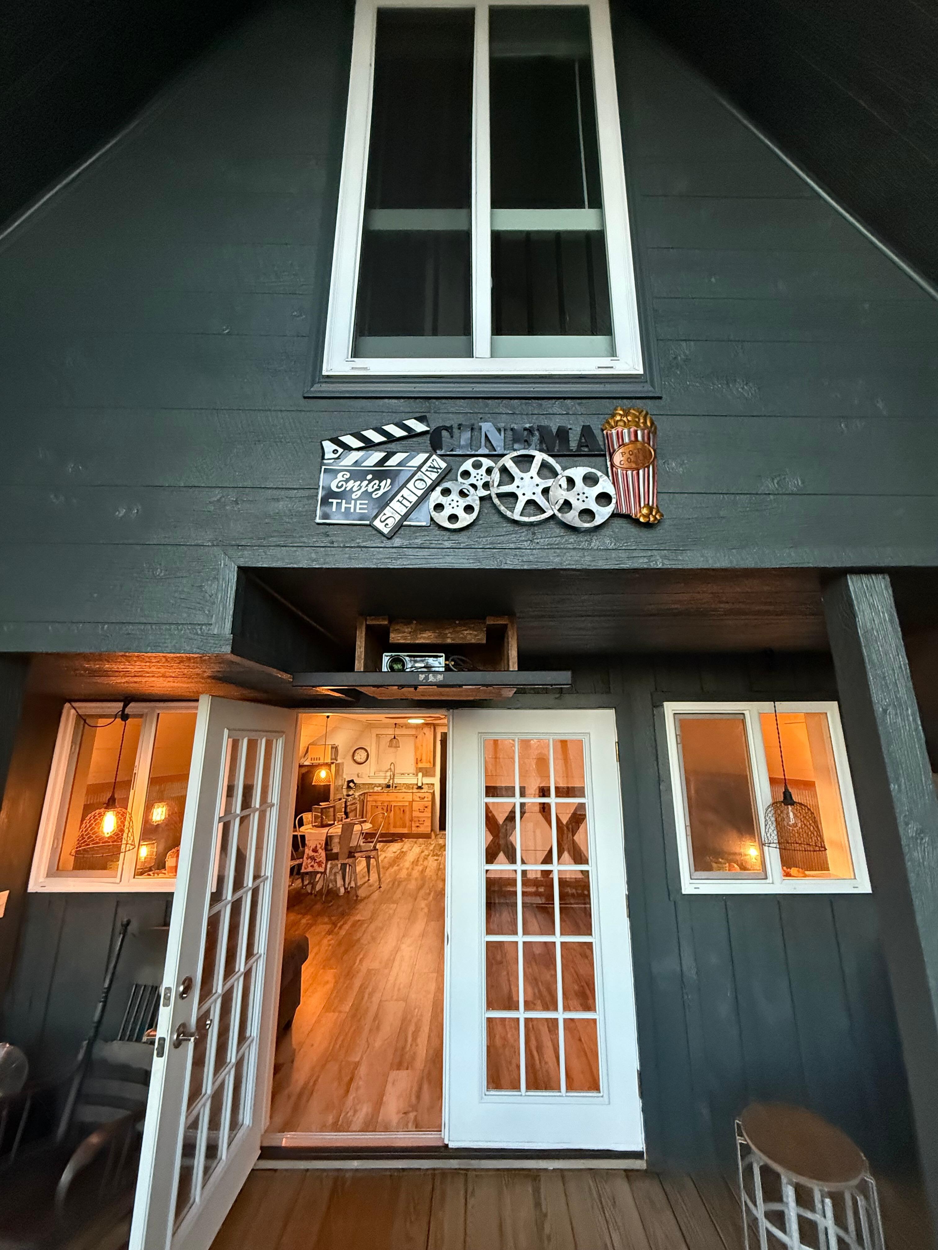 On the back porch, looking back into the house. Movie projector below, bathroom window above.
