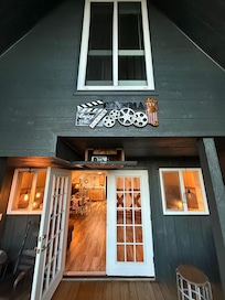 On the back porch, looking back into the house. Movie projector below, bathroom window above.