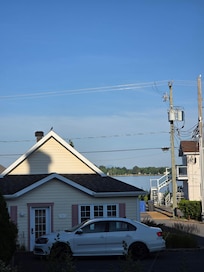 View of lake from terrace of room 101. One of the hotels' cottages is shown behind the car.