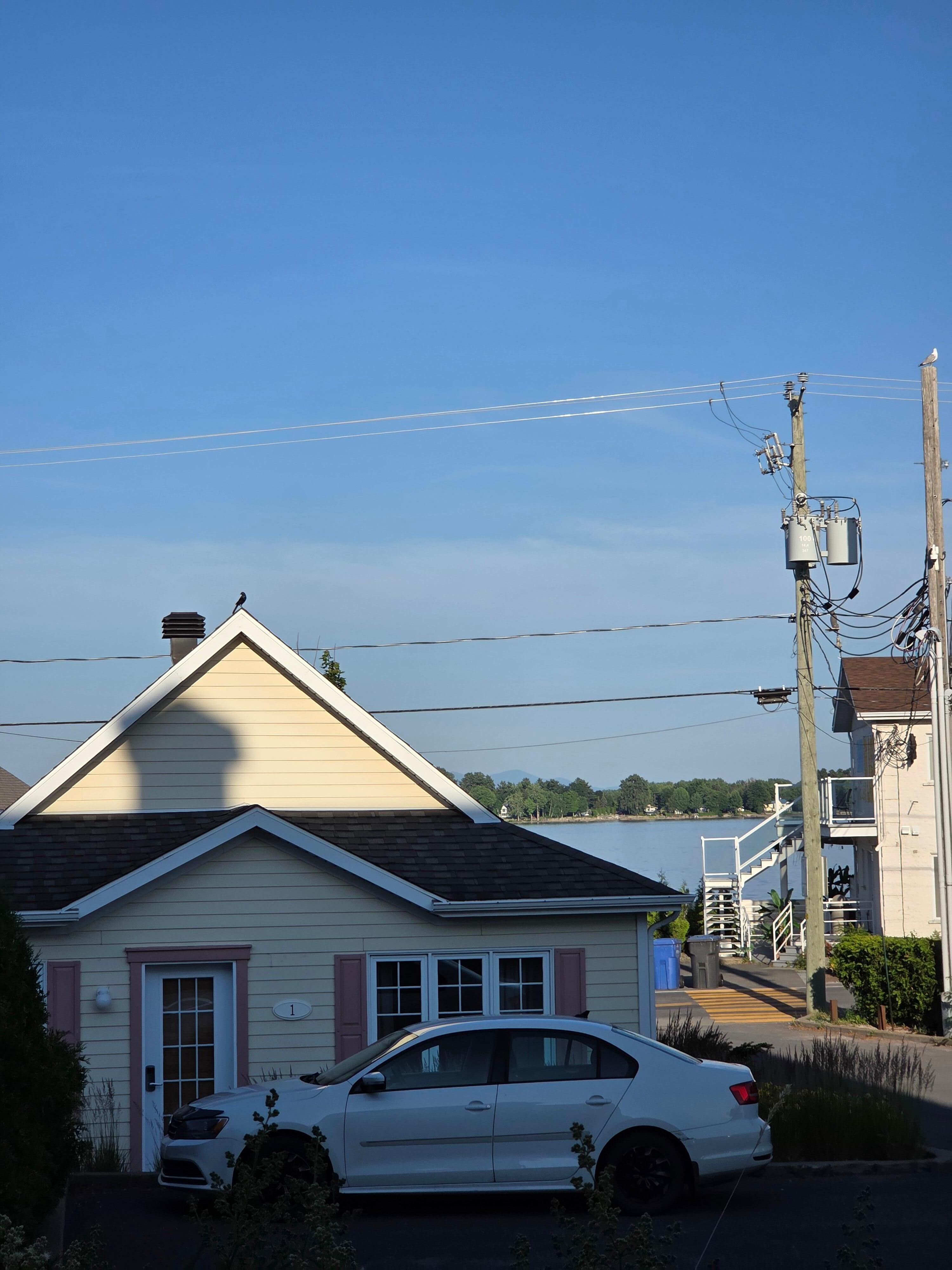View of lake from terrace of room 101. One of the hotels' cottages is shown behind the car.
