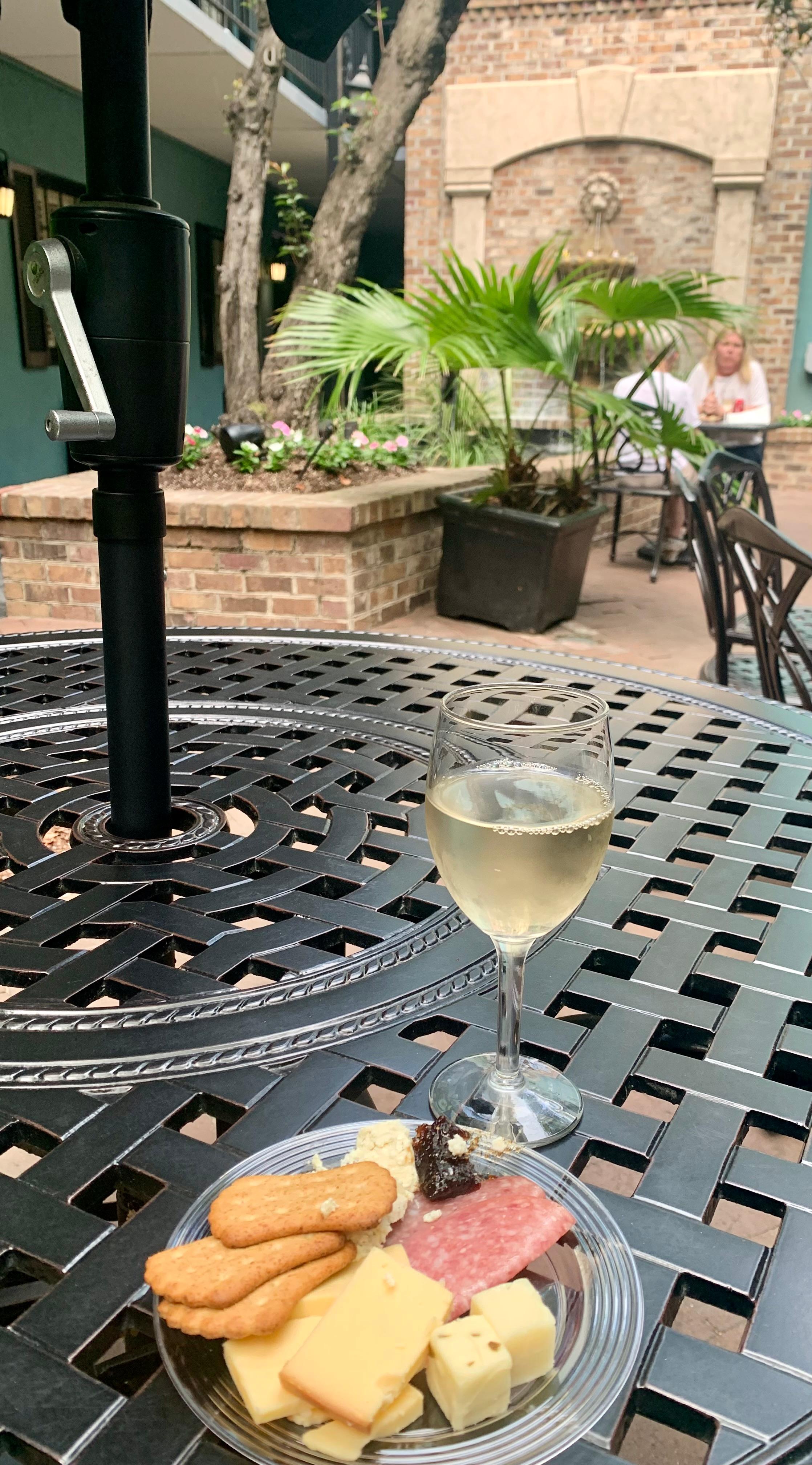 Enjoying the wine and charcuterie happy hour in the quaint courtyard. 