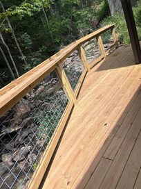 Sturdy back deck looking over waterfall and stream
