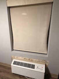 The first shade being damaged, as well as the unpainted wall.