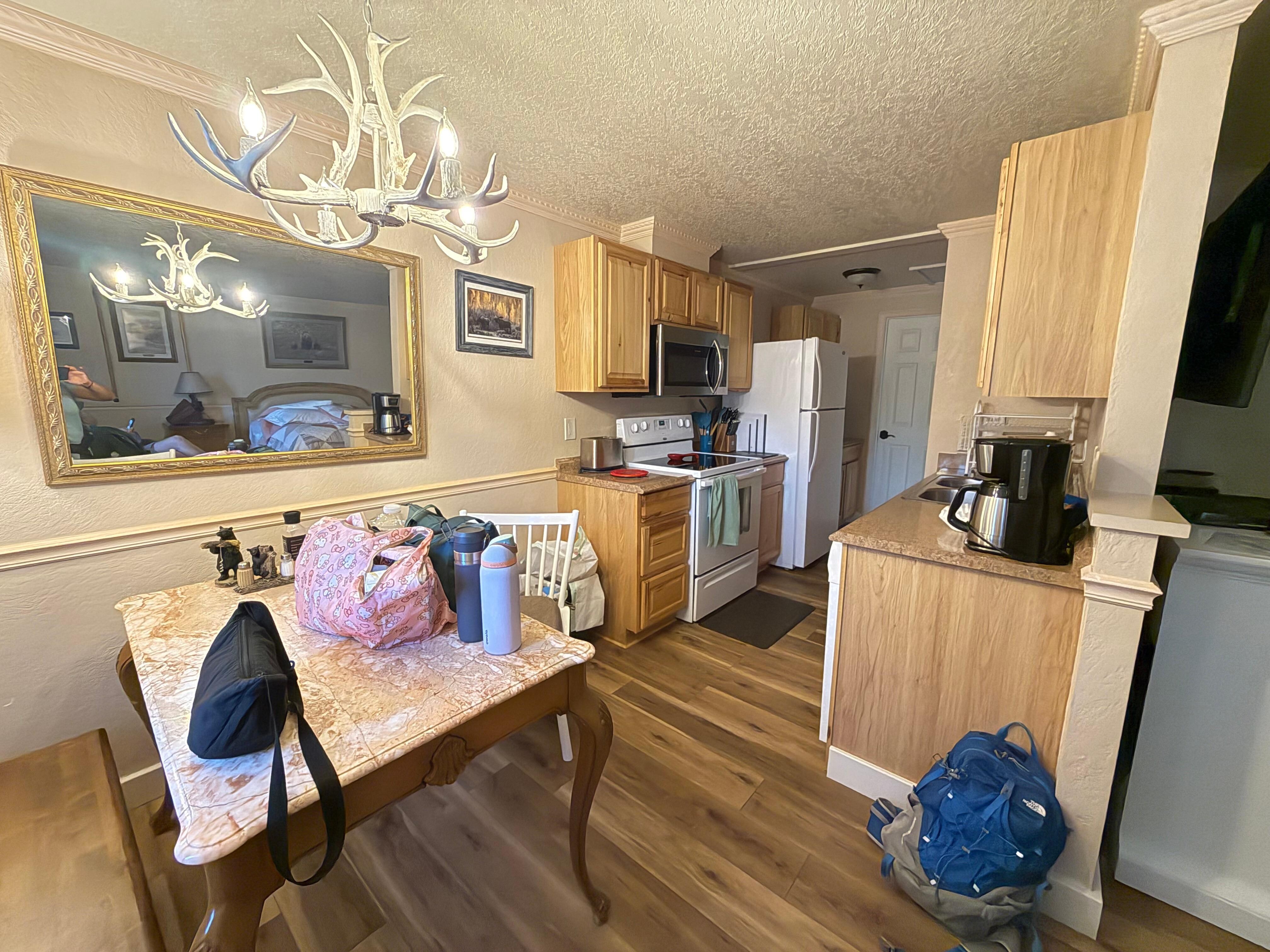 Dining area, kitchen and can see the door to bathroom in the back
