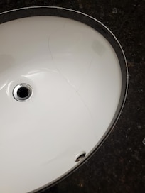 Cracked basin in bathroom.
