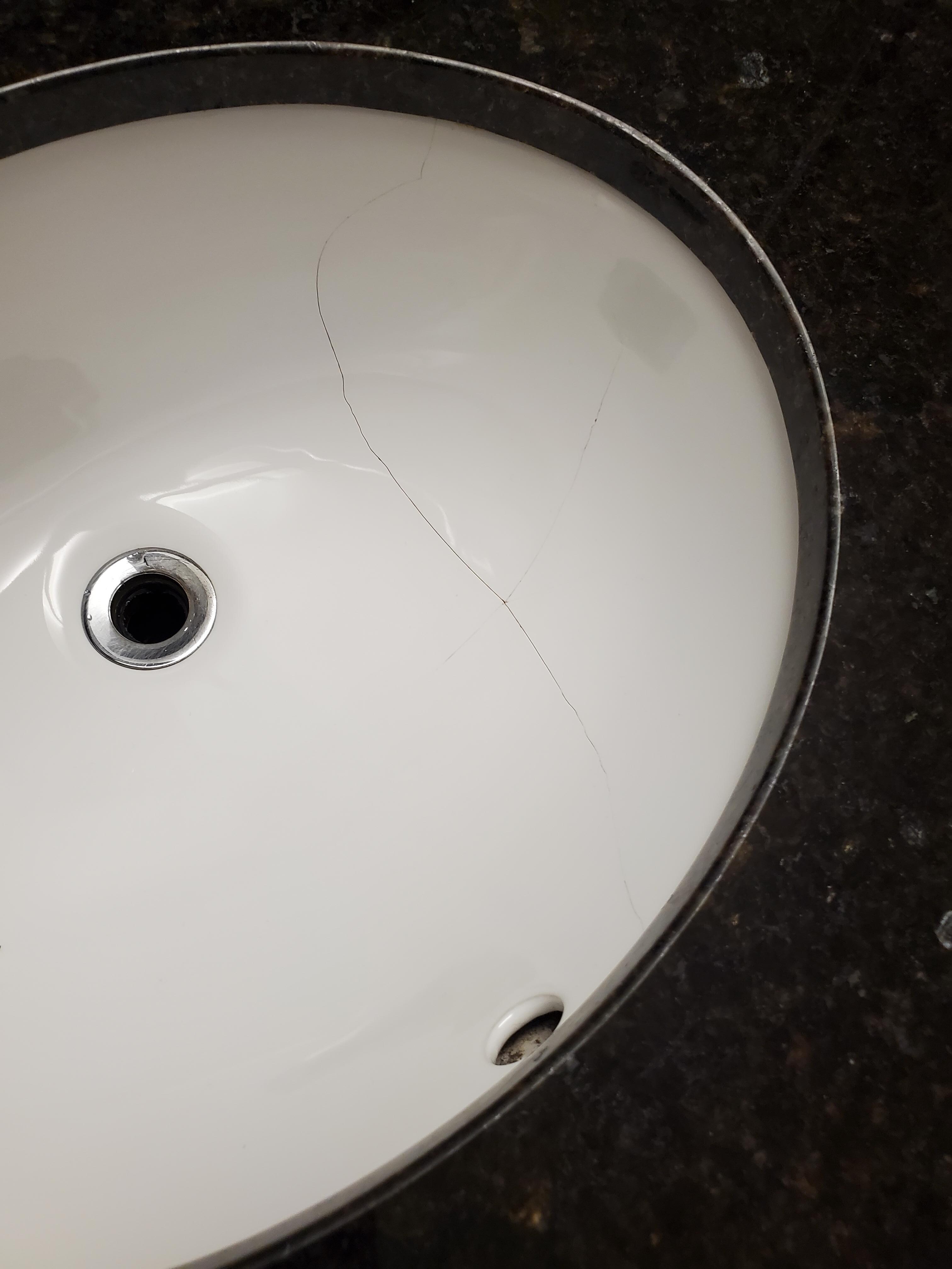 Cracked basin in bathroom.