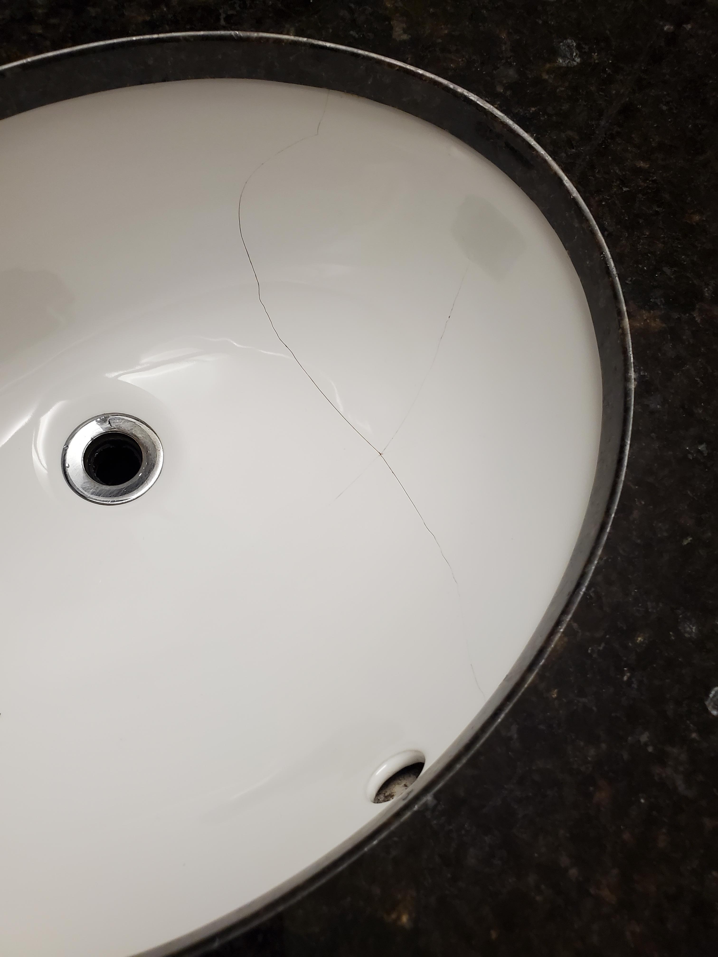 Cracked basin in bathroom.