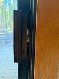 Sliding door missing panel to keep lock from being pushed I