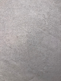 Hair clippings on wall