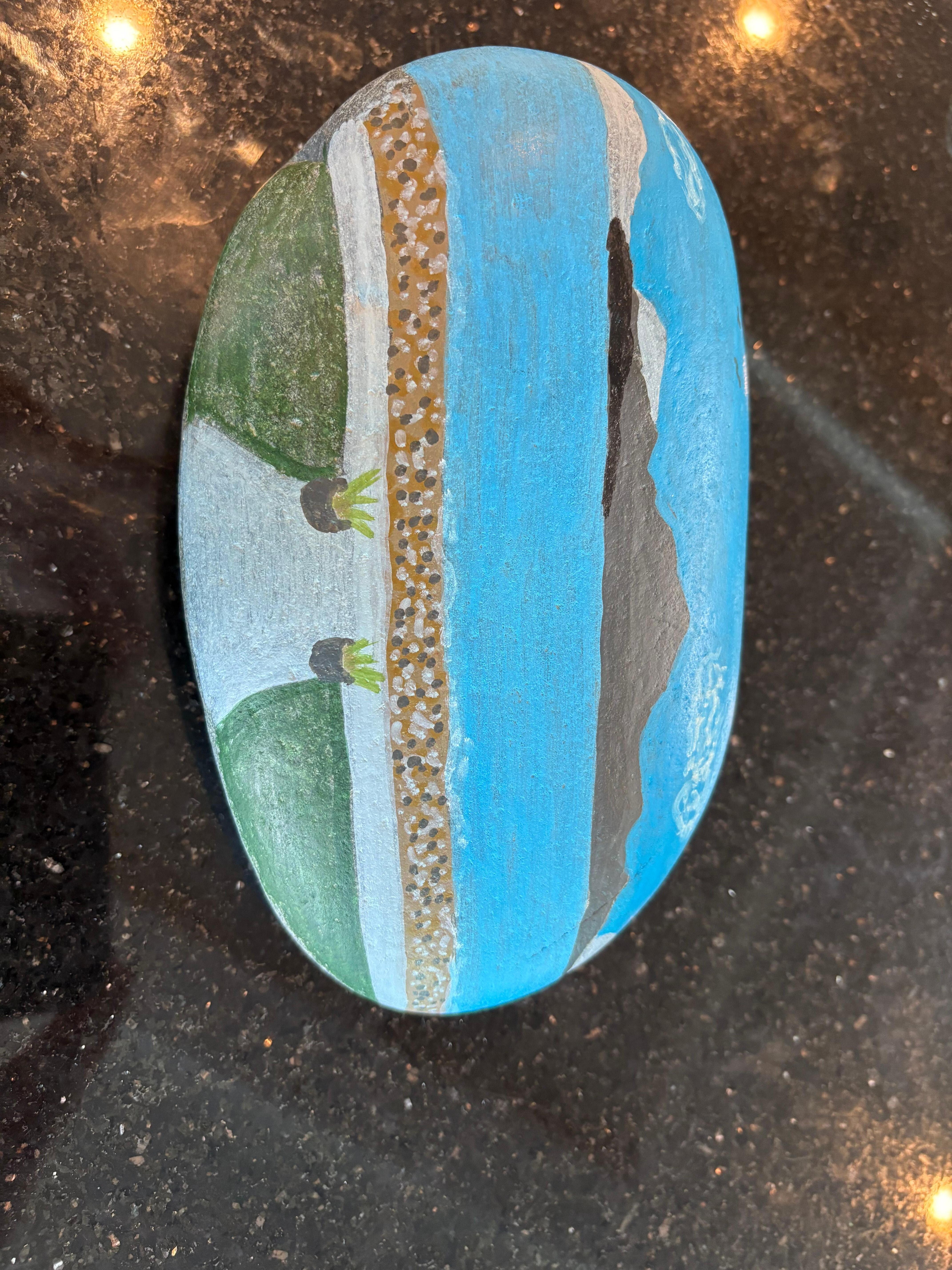 My sister in law painted this rock of the view from your rental. 