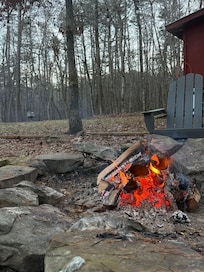 Relaxing by the fire pit-plenty of wood provided by hosts.