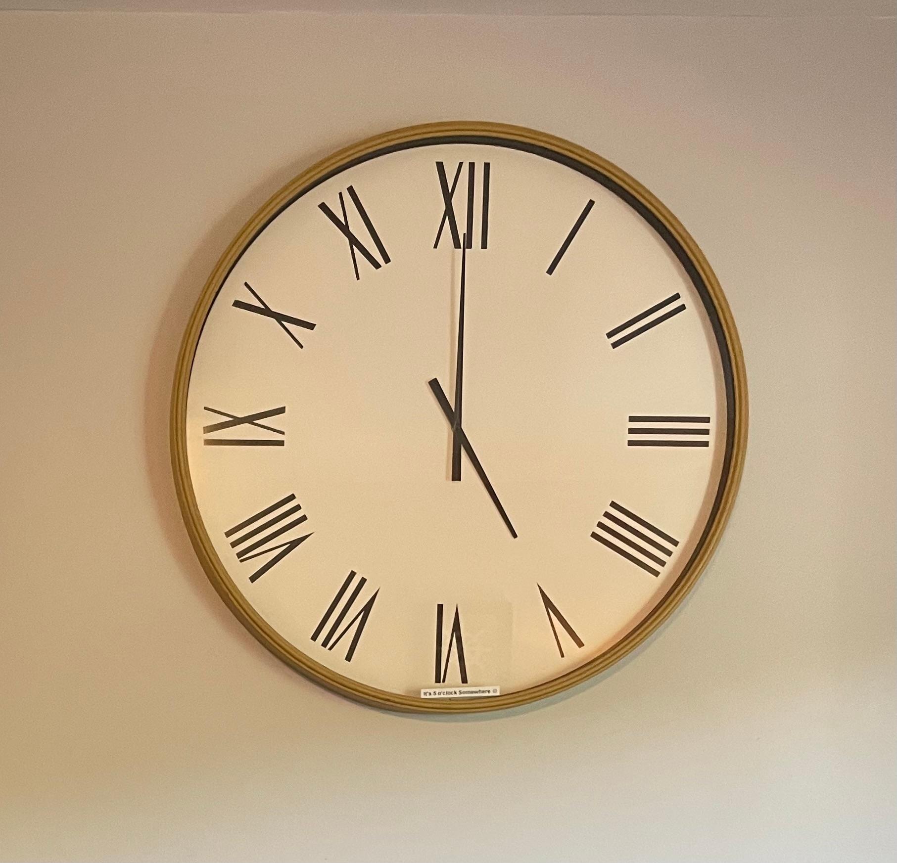 This clock is on the wall in the living room and 5:00 is always the time, as we were told that it's always 5:00 somewhere!