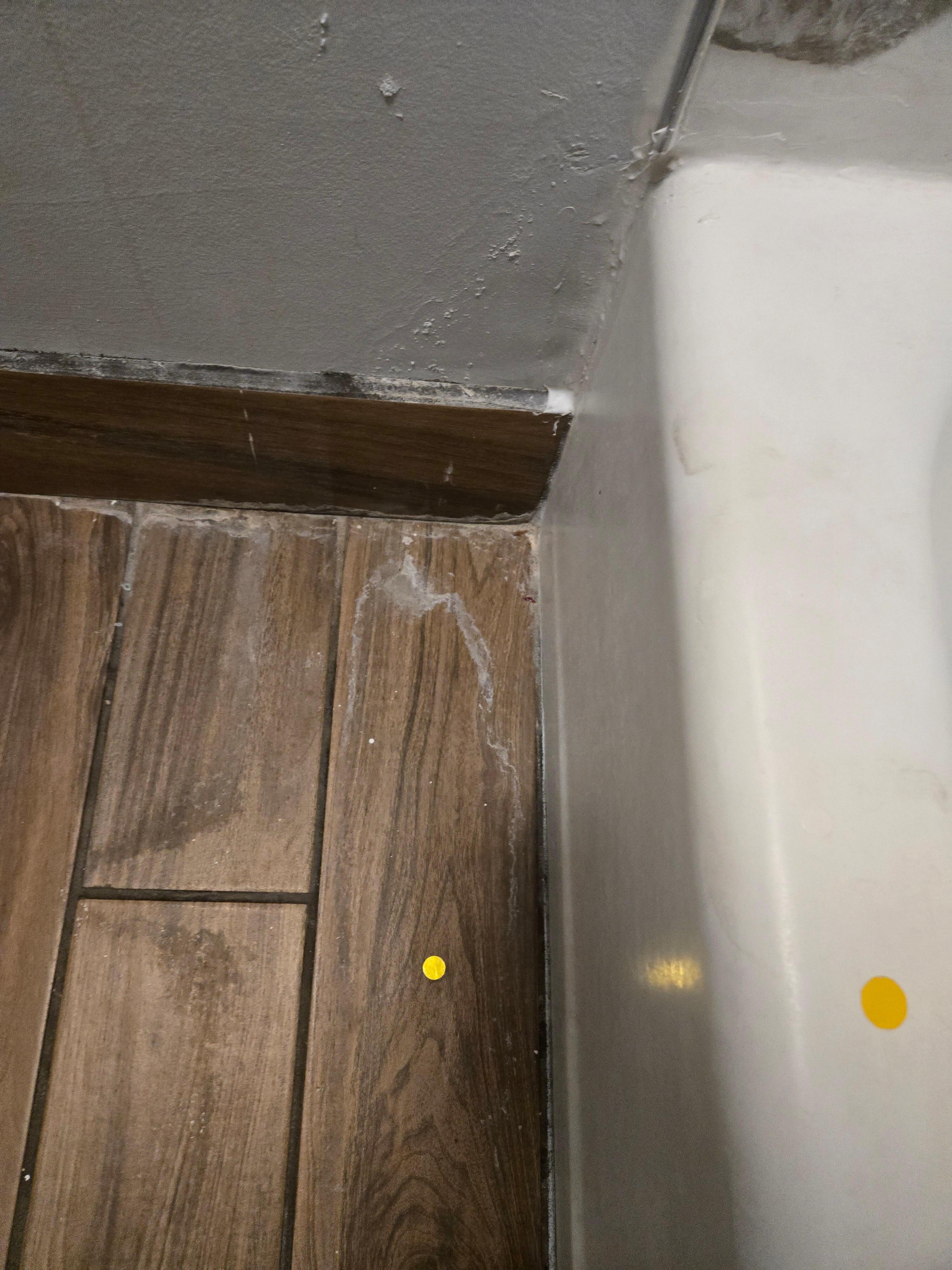 Used floss and other debris on floor in bathroom 