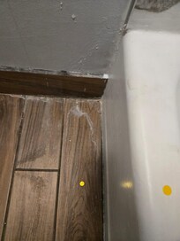 Used floss and other debris on floor in bathroom