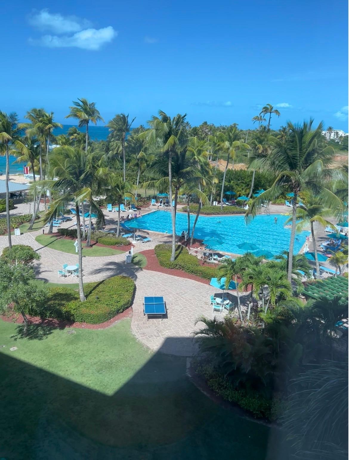 Window/living room view to pool, restaurant/bar and private beach.