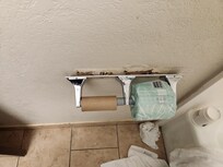 Toilet paper fell off wall again nothing was done after management was tols