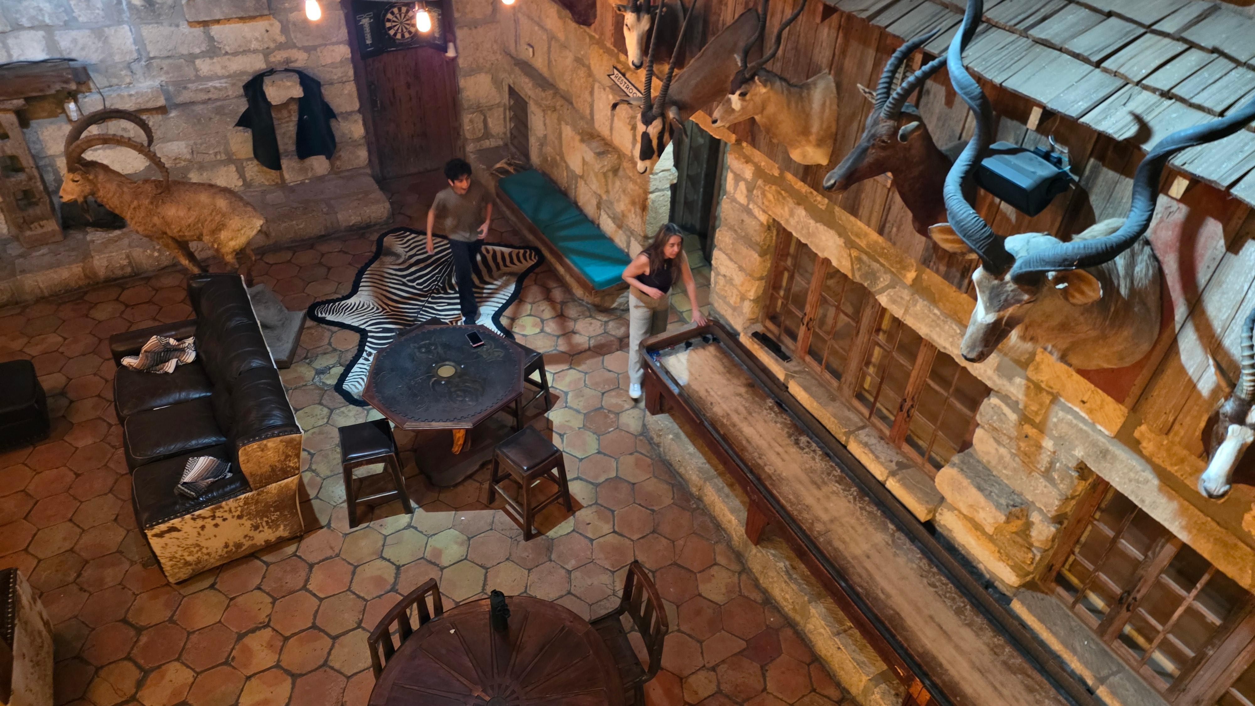 The main hall full of games and an amazing chimey with a vintage bar.