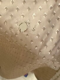 Looks like a cigarette hole in the shower curtain