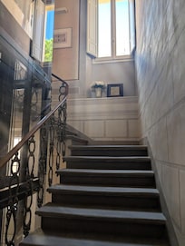 Stairwell behind glass elevator