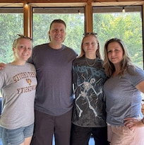 Family photo in the screened in porch