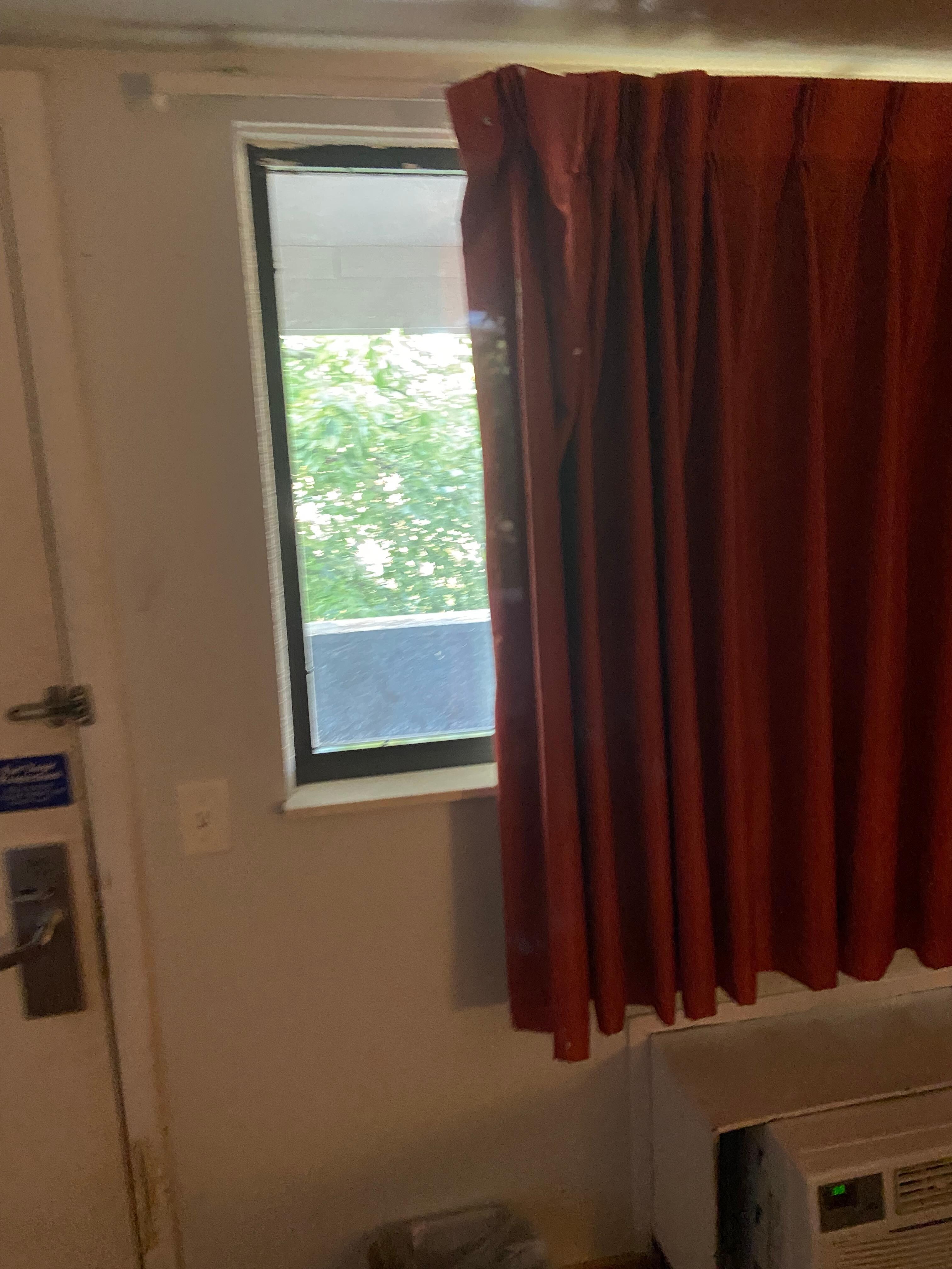 Curtains were barely hanging on.