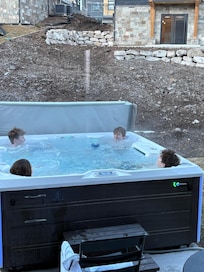 Hot tub on back patio w/ basket of plush towels just inside the back door was on point!