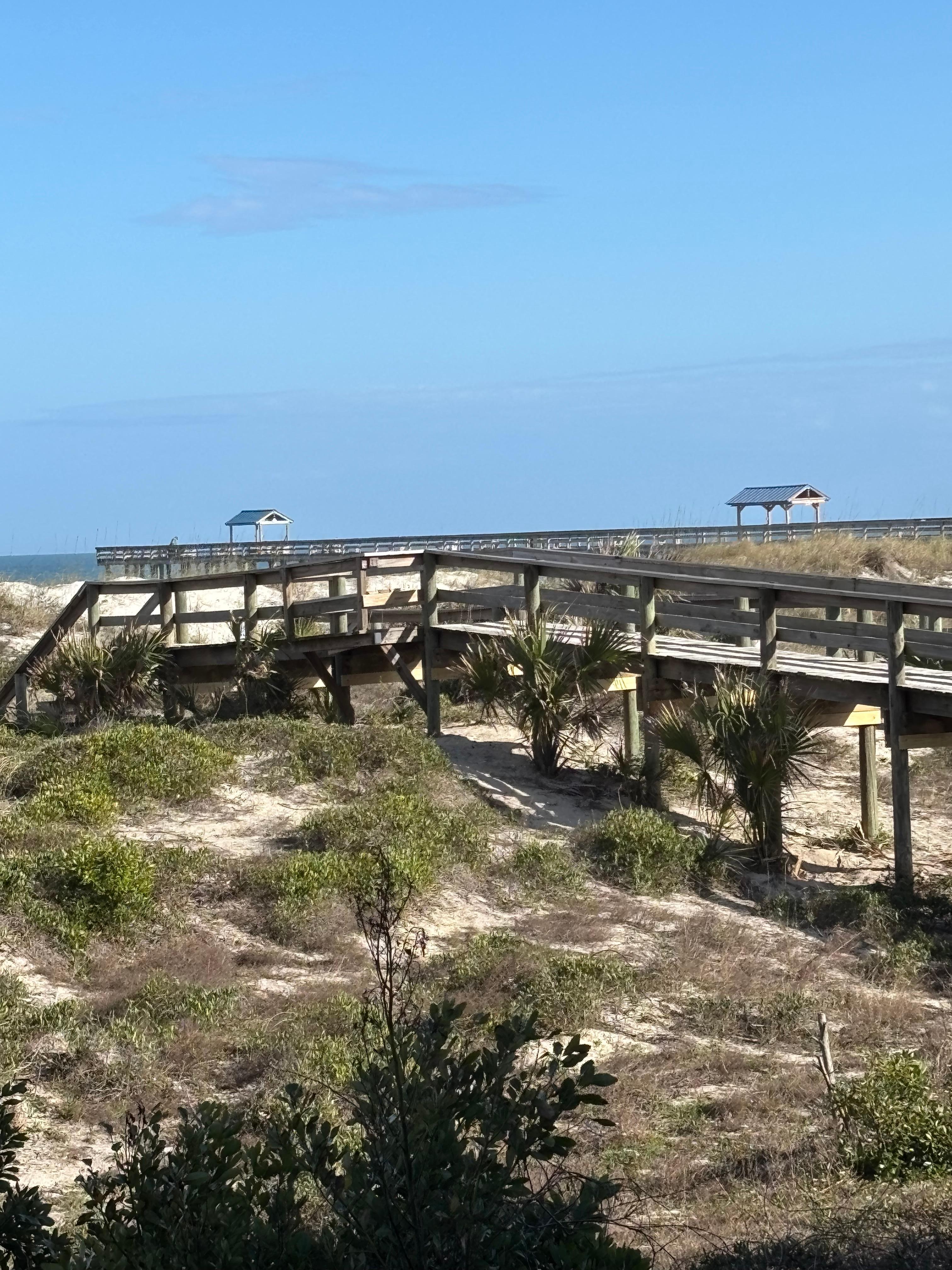Private boardwalk to the beach with a shower and hose to rinse your feet and chairs. 