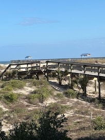 Private boardwalk to the beach with a shower and hose to rinse your feet and chairs.