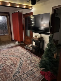 TV, laundry room on left and bathroom on right