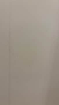 The shower wall opposite of the shower head had dirt on it