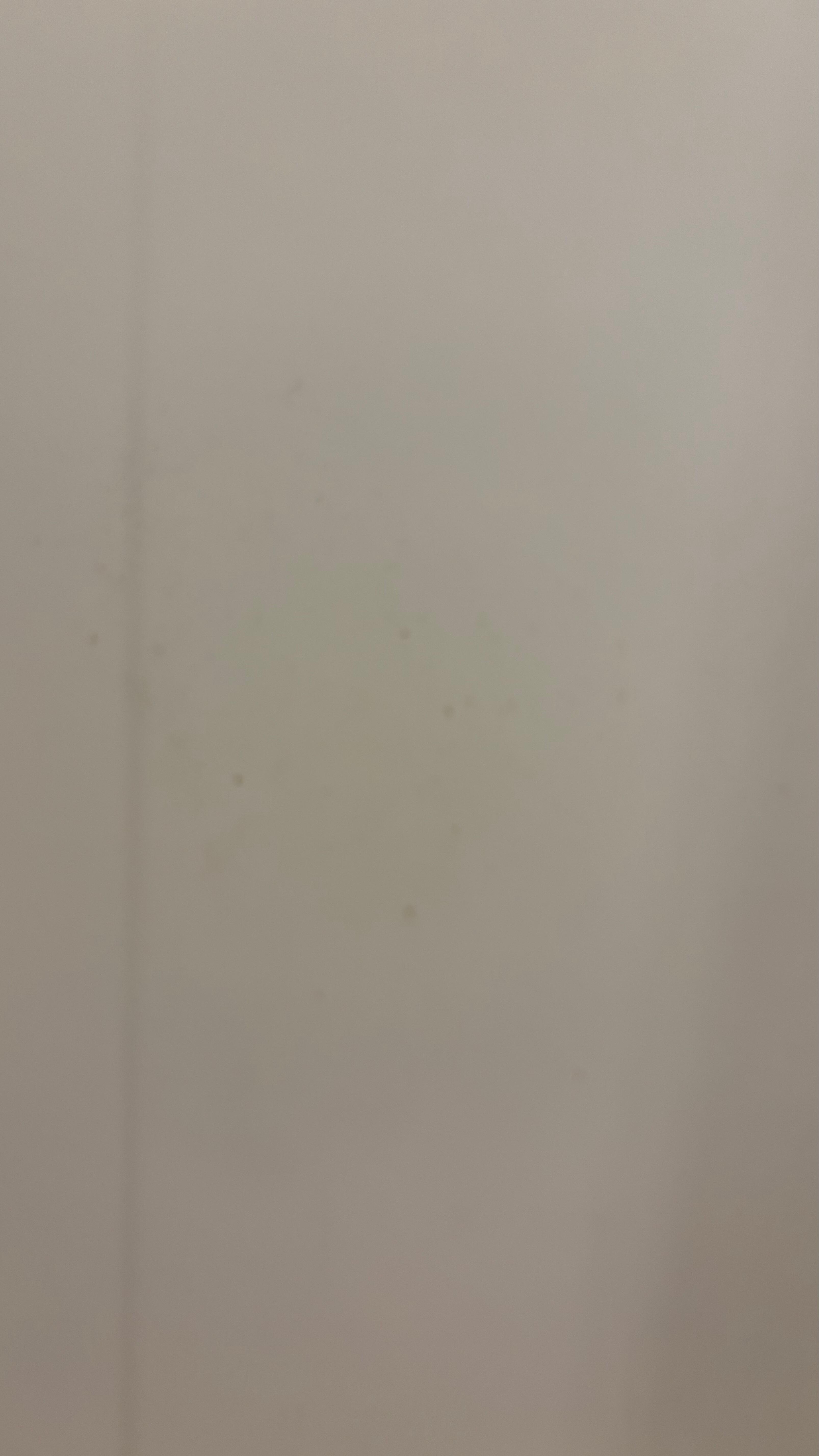 The shower wall opposite of the shower head had dirt on it