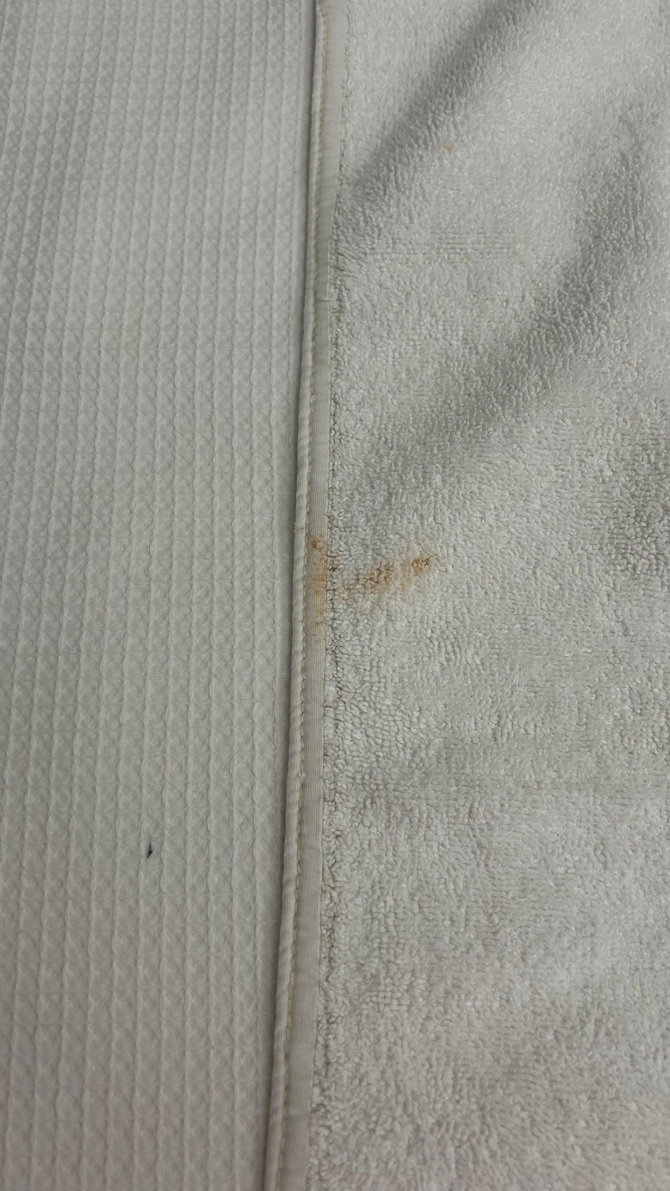 Towel with makeup stains.