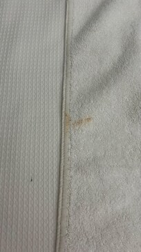 Towel with makeup stains.