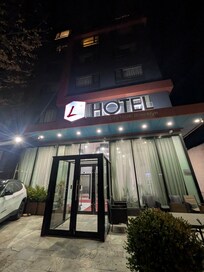 Front of the building. It is between a couple buildings in the area.