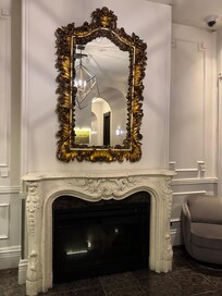 Fireplace and beautiful mirror near the hotel lobby