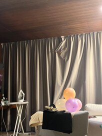 This was us using a hanger to clamp the curtains closed so we could have some privacy in our room at night.