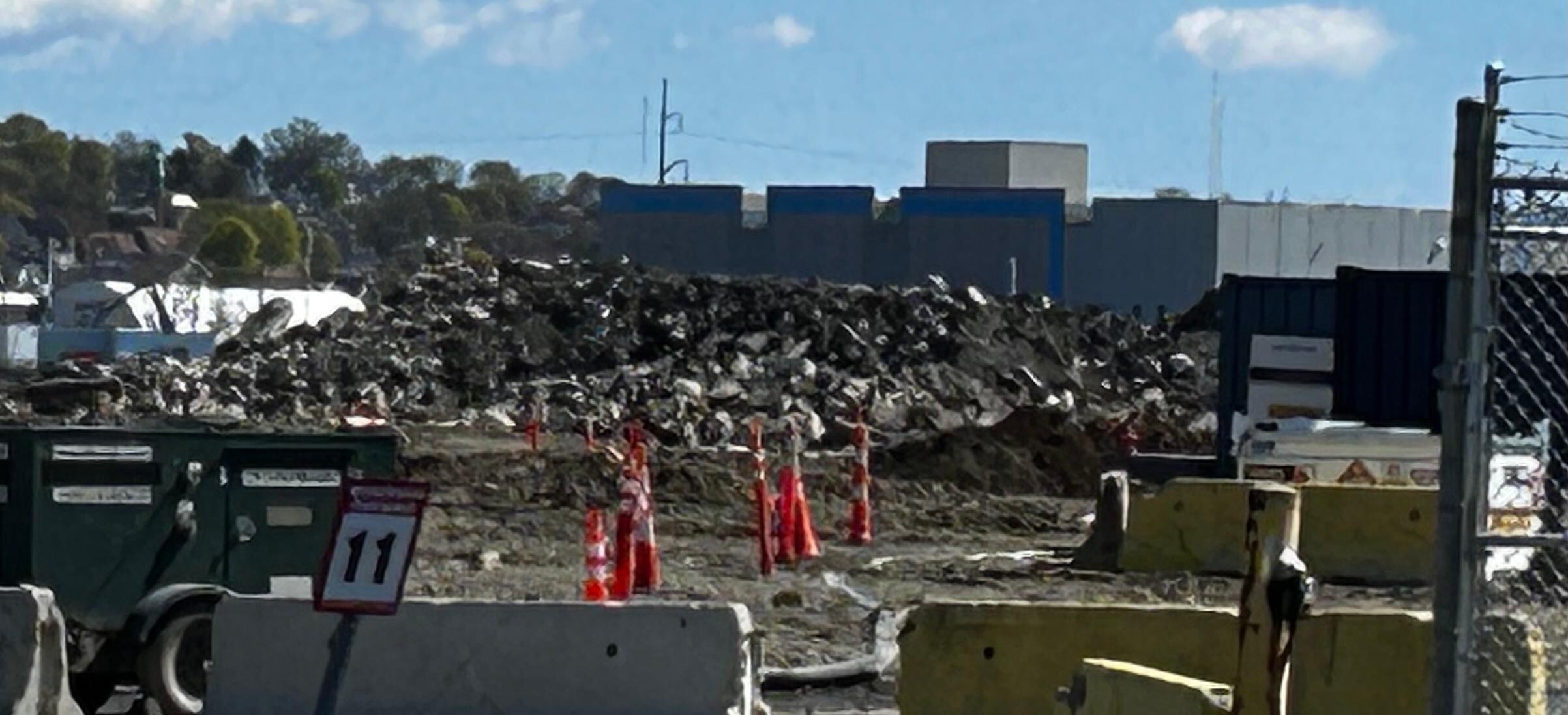 Rubble right next to building that crews worked on with jackhammers.