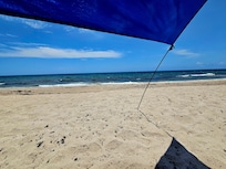 The beach at the condo, with their Shibumi shade for guests to use.
