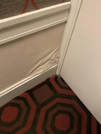 Buckled wallpaper/paint on wall as you enter room