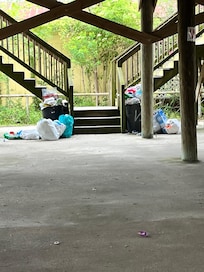 Stairs leading up to condo with trash from the weekend before.