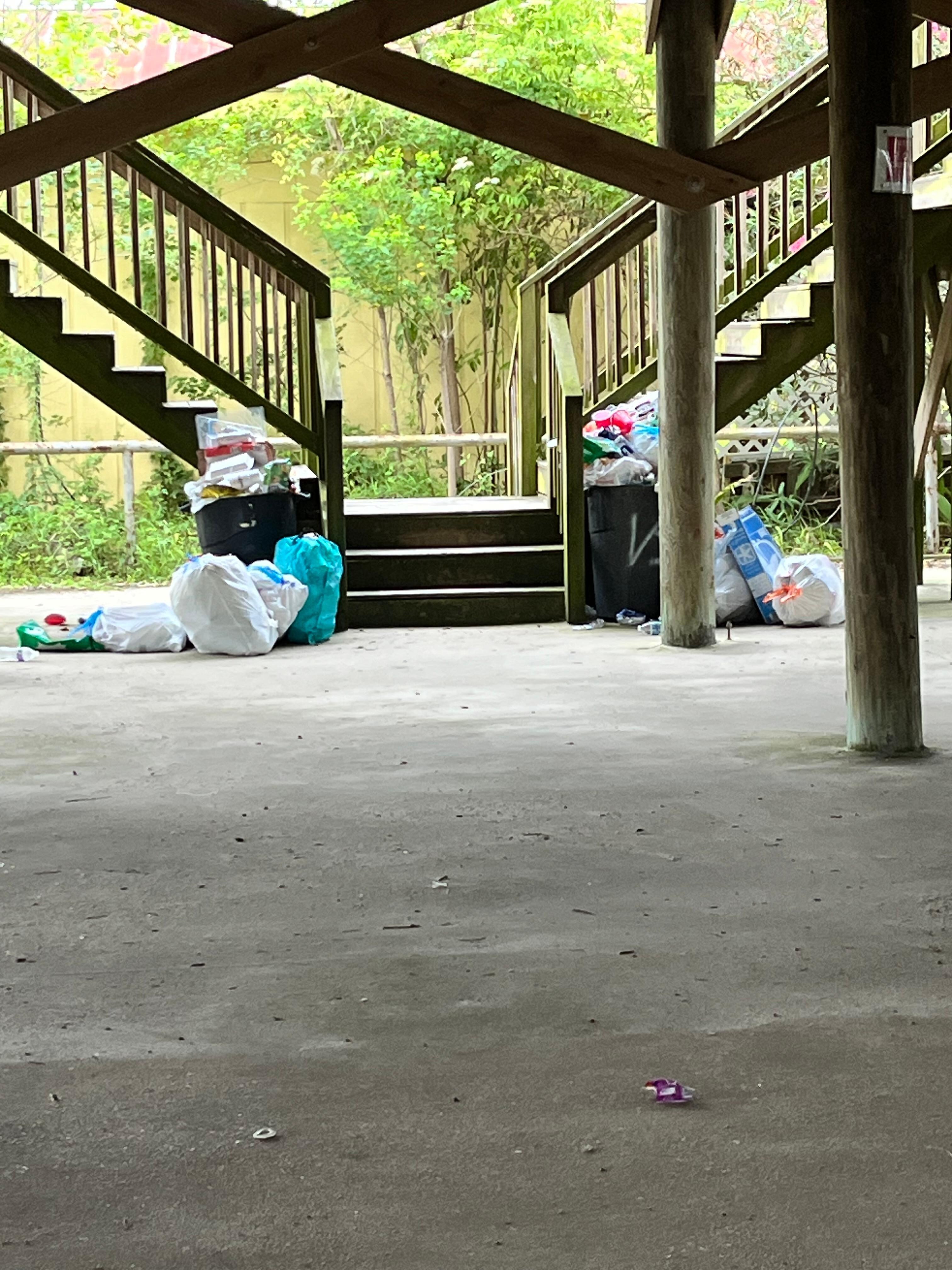 Stairs leading up to condo with trash from the weekend before.