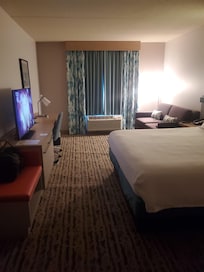 Area nice and clean with sofa on side of the bed
