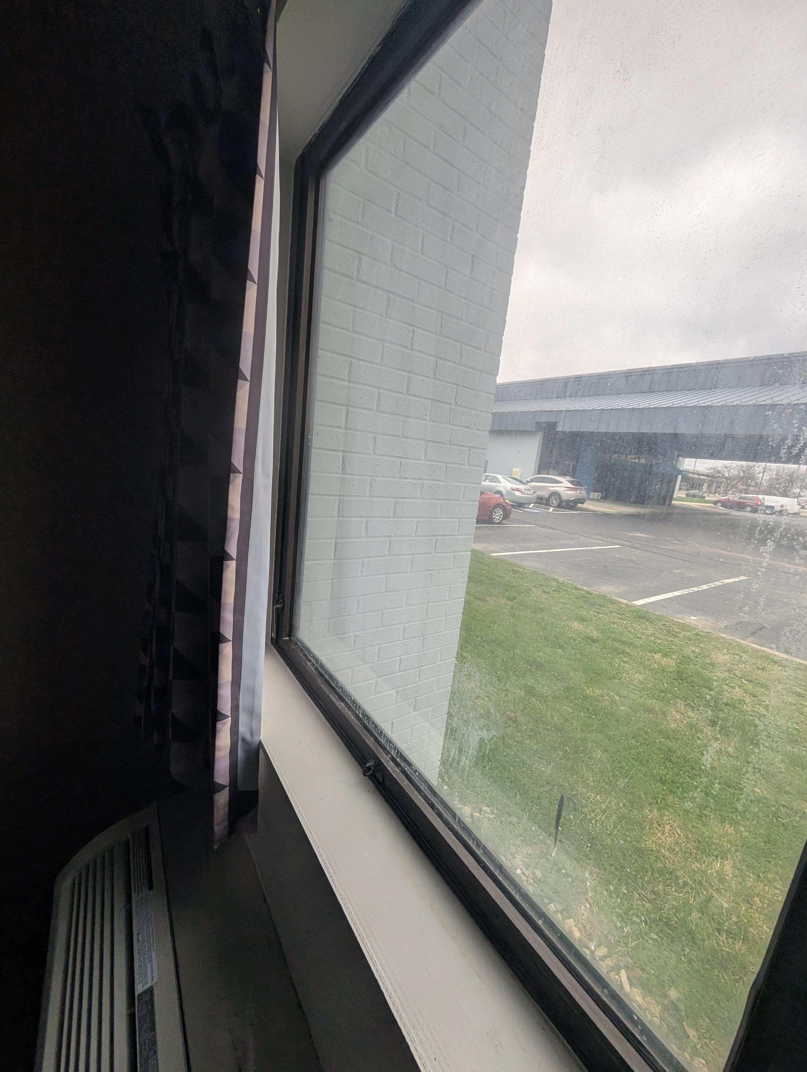 First floor window missing sheer curtain. 