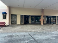 Abandoned entry way. A small sign directs you to go around the back of the building.