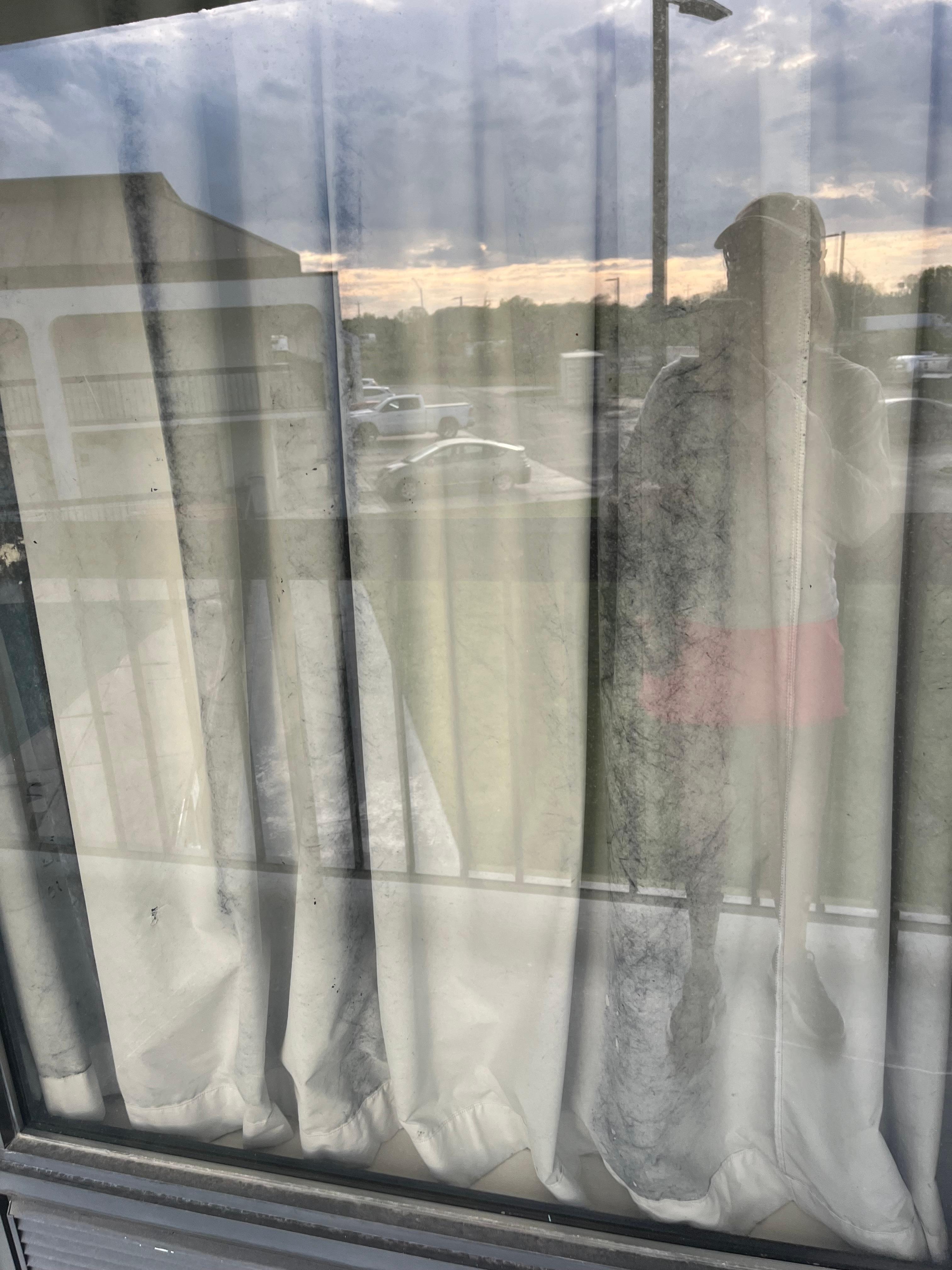 Looks like black mold on the back of the curtains and you can clearly see it when you walk by the window 