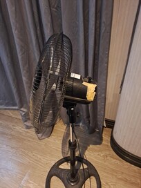 Standing fan provided to augment hot rooms. The fan was falling apart.