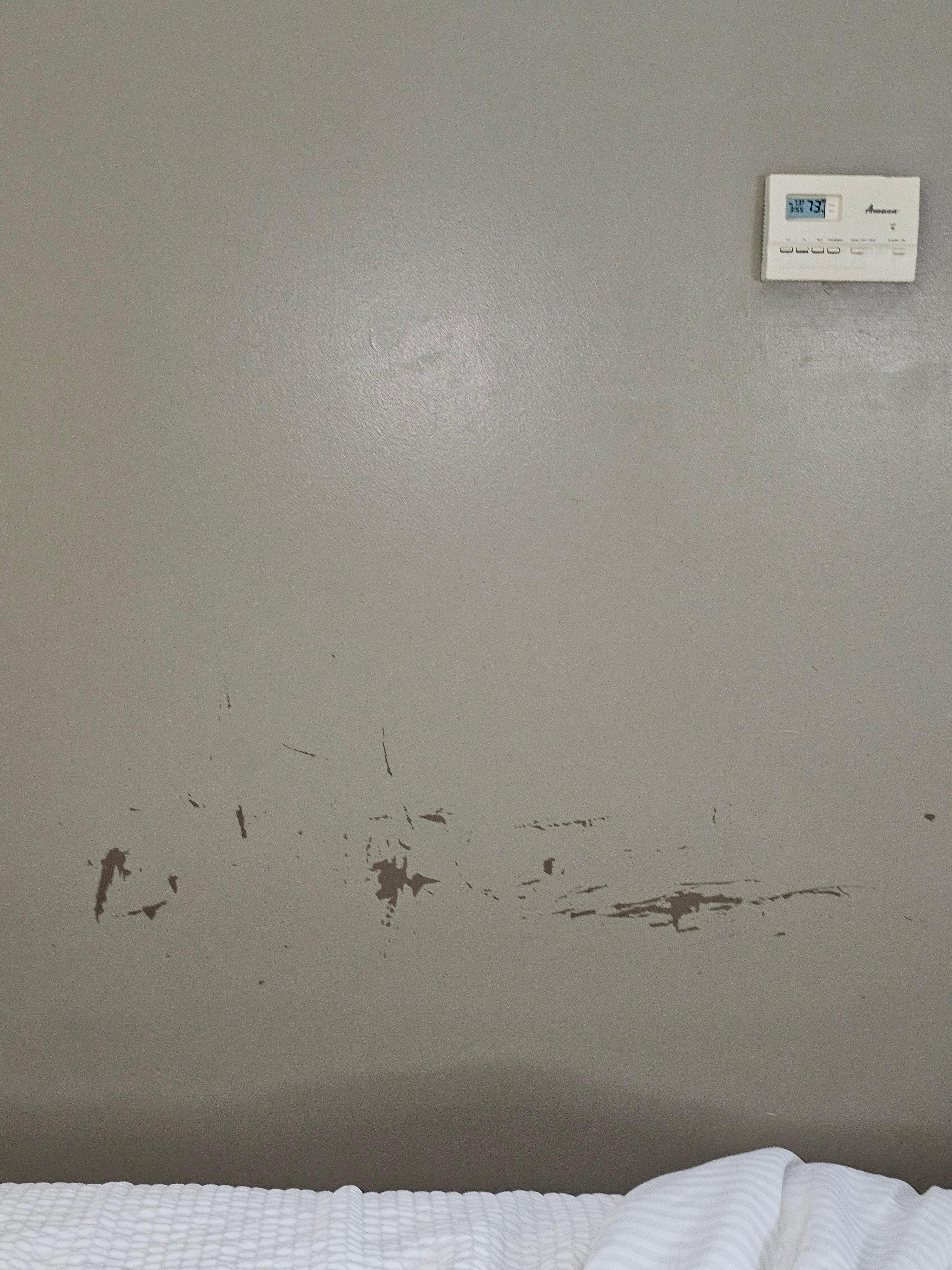 Missing paint on the wall. 