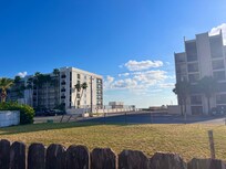 Looking over the backyard fence toward the public beach access lot.