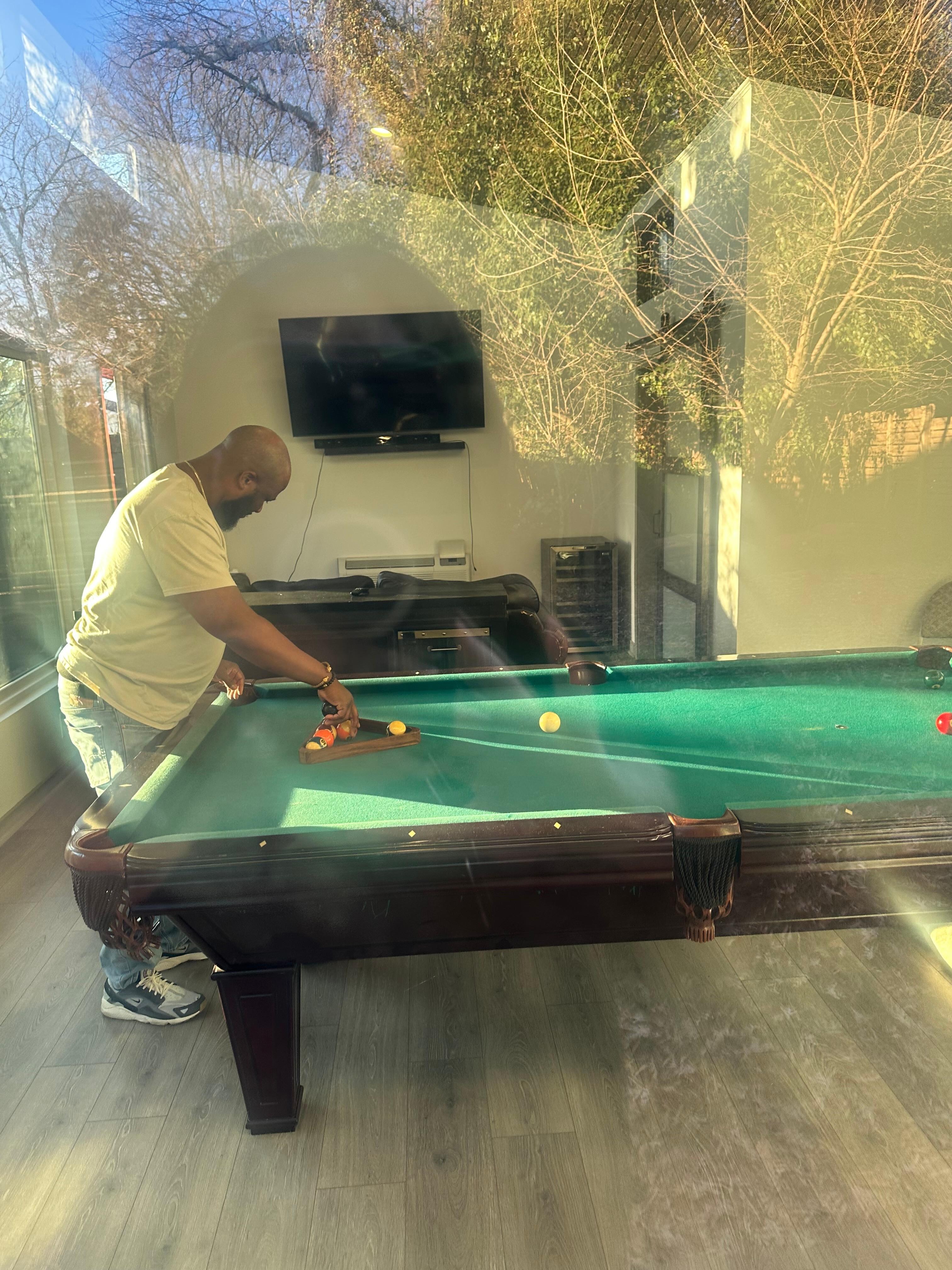 Husband in the ADU playing pool 
